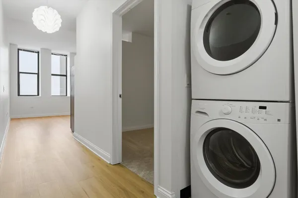a view of a hallway with washer and dryer