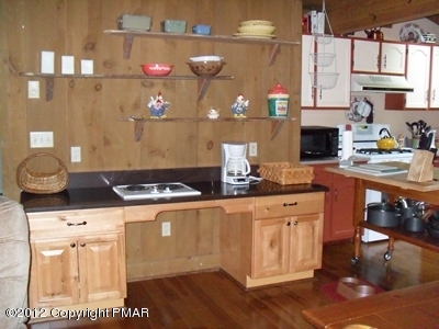 199 Fawn Road Pocono Lake, PA 18347 - Photo 12 of 31 a kitchen with granite countertop a stove and a wooden floors