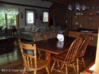 199 Fawn Road Pocono Lake, PA 18347 - Photo 13 of 31 a view of a dining room with furniture and wooden floor