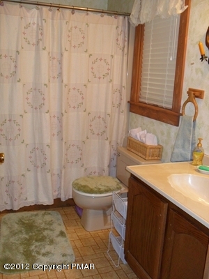 199 Fawn Road Pocono Lake, PA 18347 - Photo 17 of 31 a bathroom with a granite countertop toilet and a sink