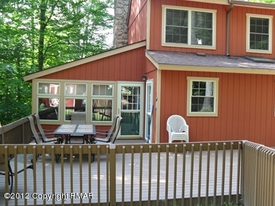 199 Fawn Road Pocono Lake, PA 18347 - Photo 5 of 31 a view of house with a chairs and table in a patio