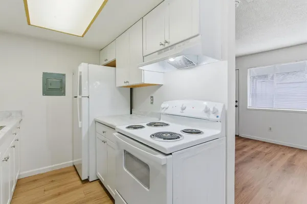 a kitchen with a sink stove and cabinets