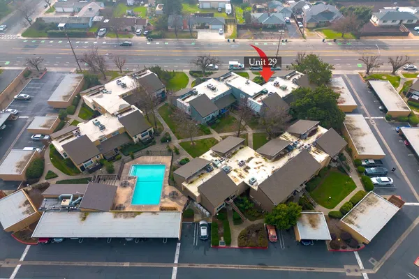 an aerial view of residential houses with outdoor space