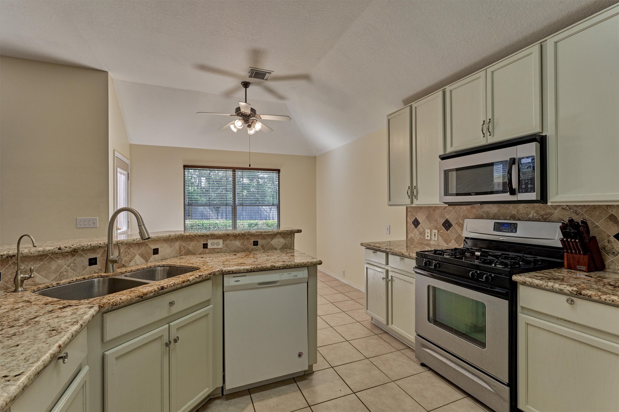 20835 Louetta Oak Drive Spring, TX 77388 - Photo 26 of 37 a kitchen with white cabinets appliances and a sink
