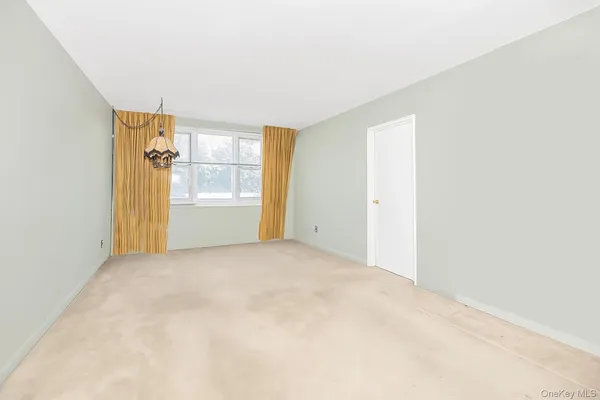 a kitchen with white cabinets and appliances