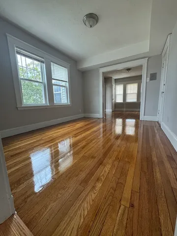 wooden floor in an empty room with a window