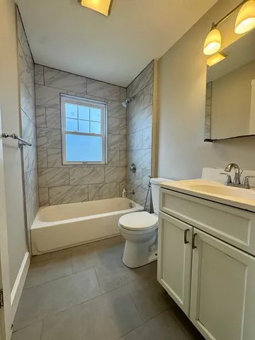 a bathroom with a toilet a sink and bathtub