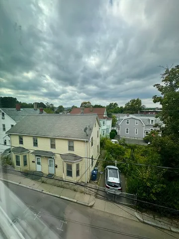 an aerial view of a residential apartment building with a yard