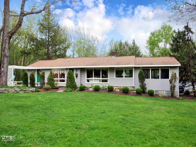3 Osborn Farm Road Weston, CT 06883 - Photo 1 of 1 a front view of a house with a yard