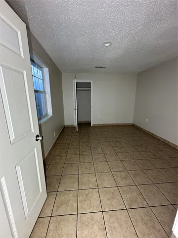 a view of an empty room and a window