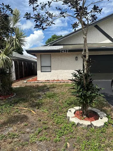 a vase of flowers sitting on a floor