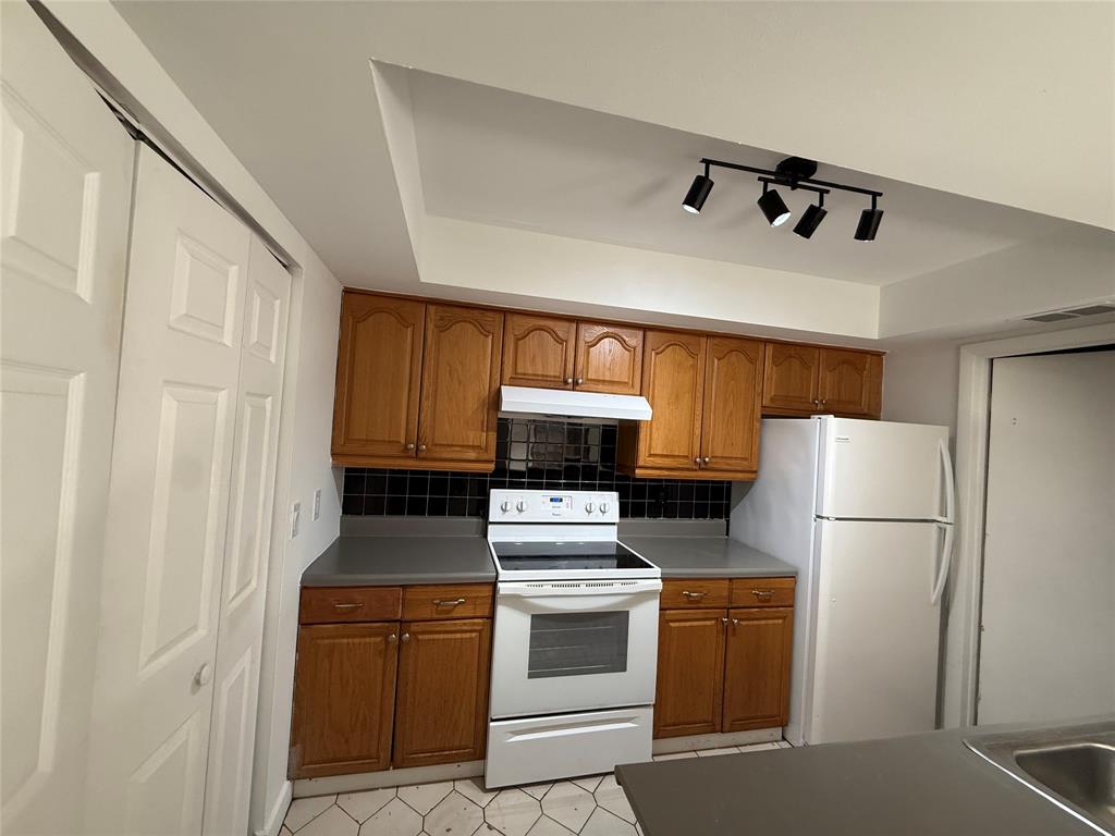 7427 Southwest 13th Street North Lauderdale, FL 33068 - Photo 44 of 49 a kitchen with a refrigerator sink and cabinets