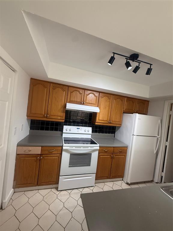 7427 Southwest 13th Street North Lauderdale, FL 33068 - Photo 10 of 49 a kitchen with granite countertop a refrigerator and a stove
