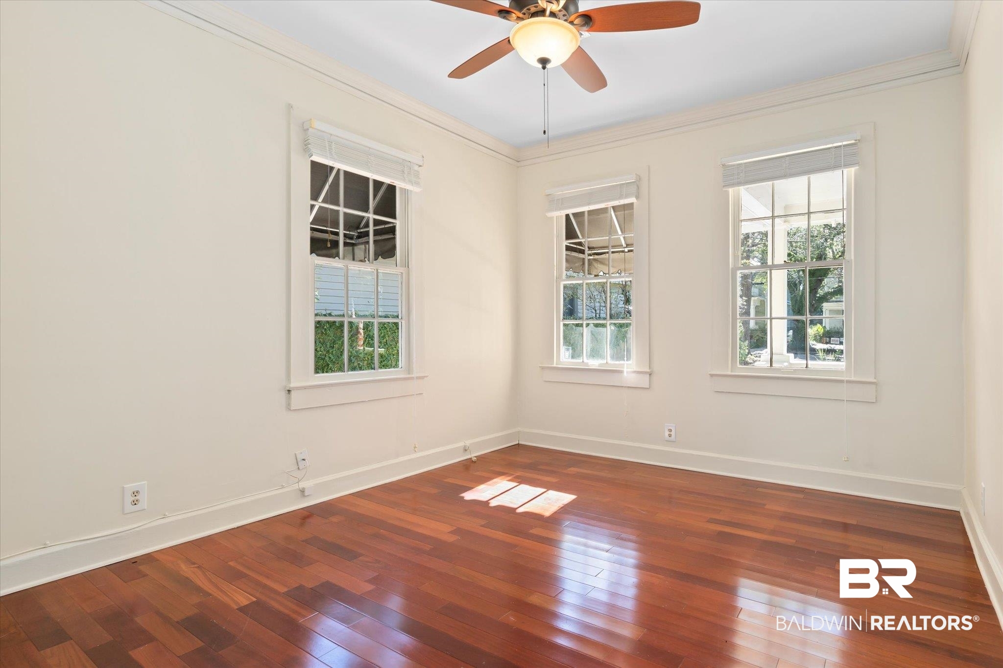 1220 Elmira Street Mobile, AL 36604 - Photo 11 of 20 Spare room with dark hardwood / wood-style flooring, ceiling fan, and crown molding