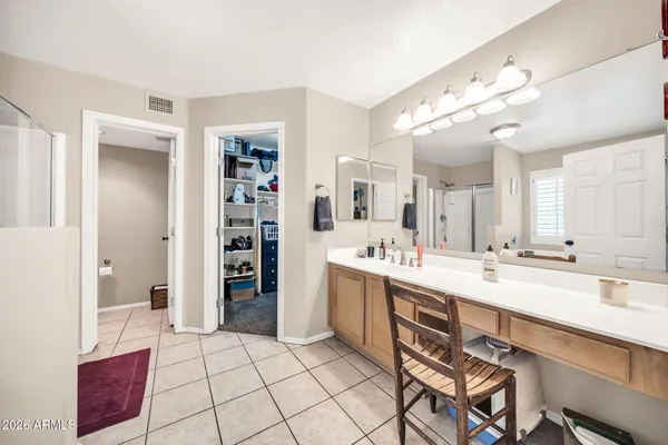 a large white kitchen with a sink and cabinets