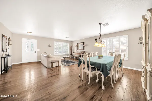 a view of a dining room with furniture and wooden floor