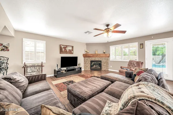 a living room with furniture a large window and a fireplace