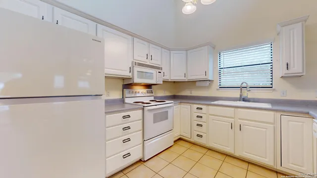 a kitchen with cabinets stainless steel appliances and a sink