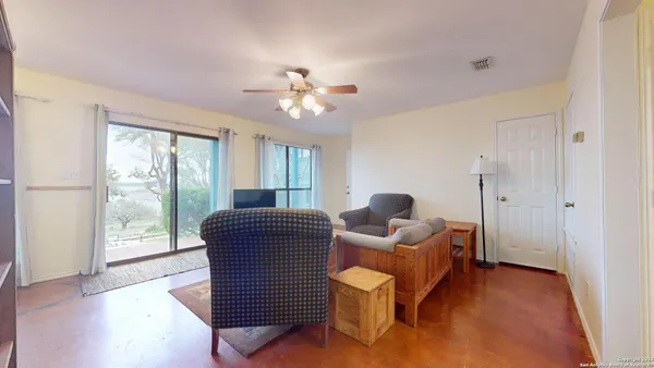 a living room with furniture and a large window