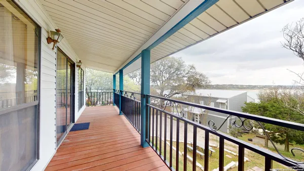 a view of a balcony with wooden floor
