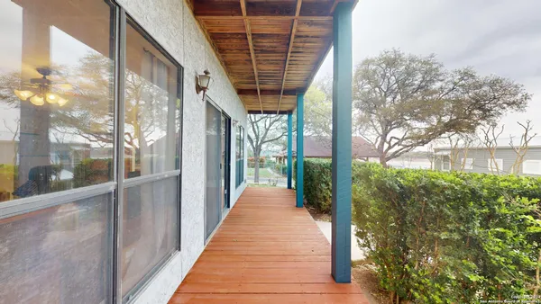 a view of balcony with a floor to ceiling window and yard