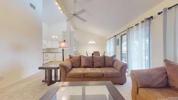 a living room with furniture and a large window