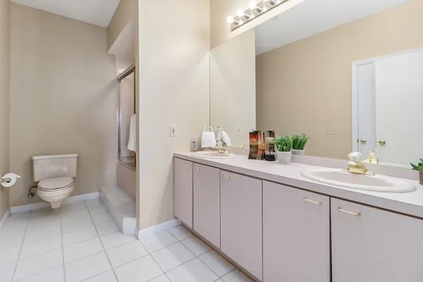 a bathroom with a sink a toilet and a mirror