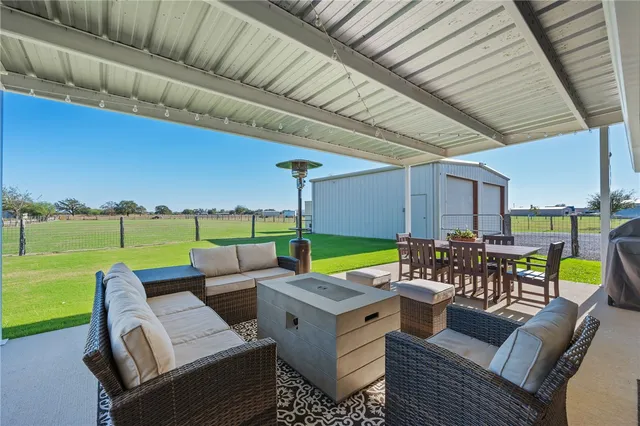 a view of a patio with couches chairs and a table