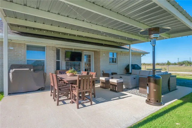 a view of a patio with a dining table and chairs