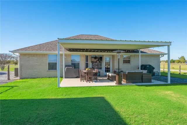 a view of a house with a yard porch and sitting area