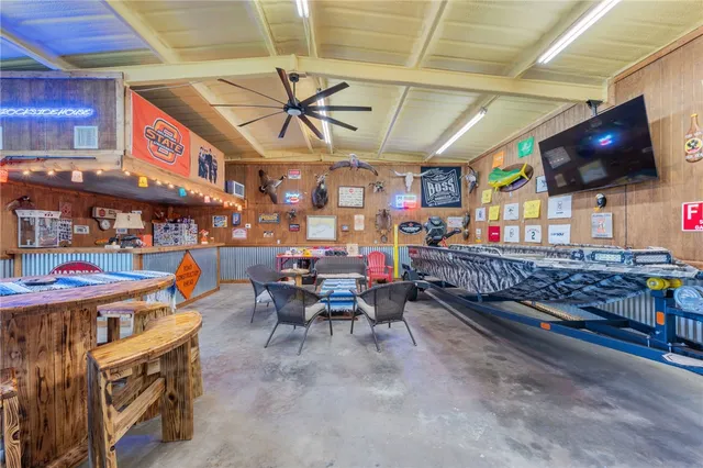 a living room filled with furniture and a flat screen tv