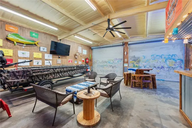 a roof deck with a dining table and chairs with wooden floor