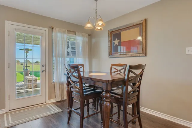a view of a dining room with furniture wooden floor and a chandelier