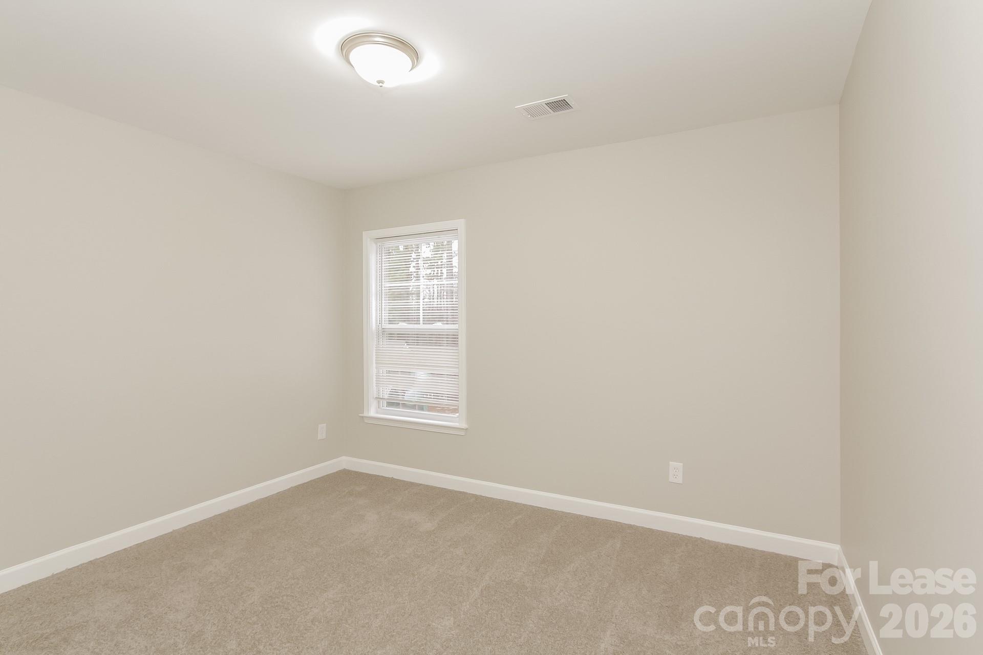 11004 Greenhead View Road Charlotte, NC 28262 - Photo 12 of 17 an empty room with windows
