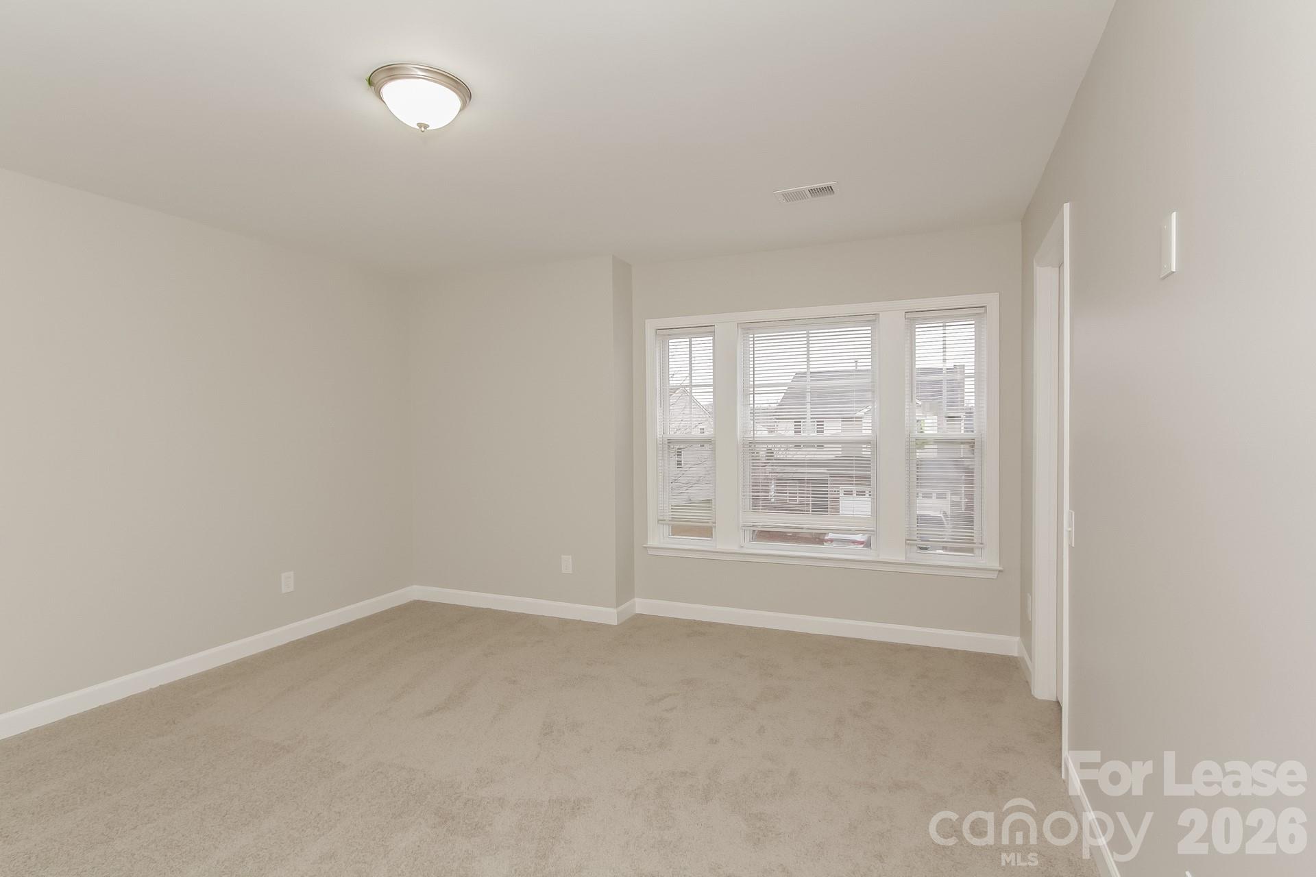 11004 Greenhead View Road Charlotte, NC 28262 - Photo 7 of 17 an empty room with a window
