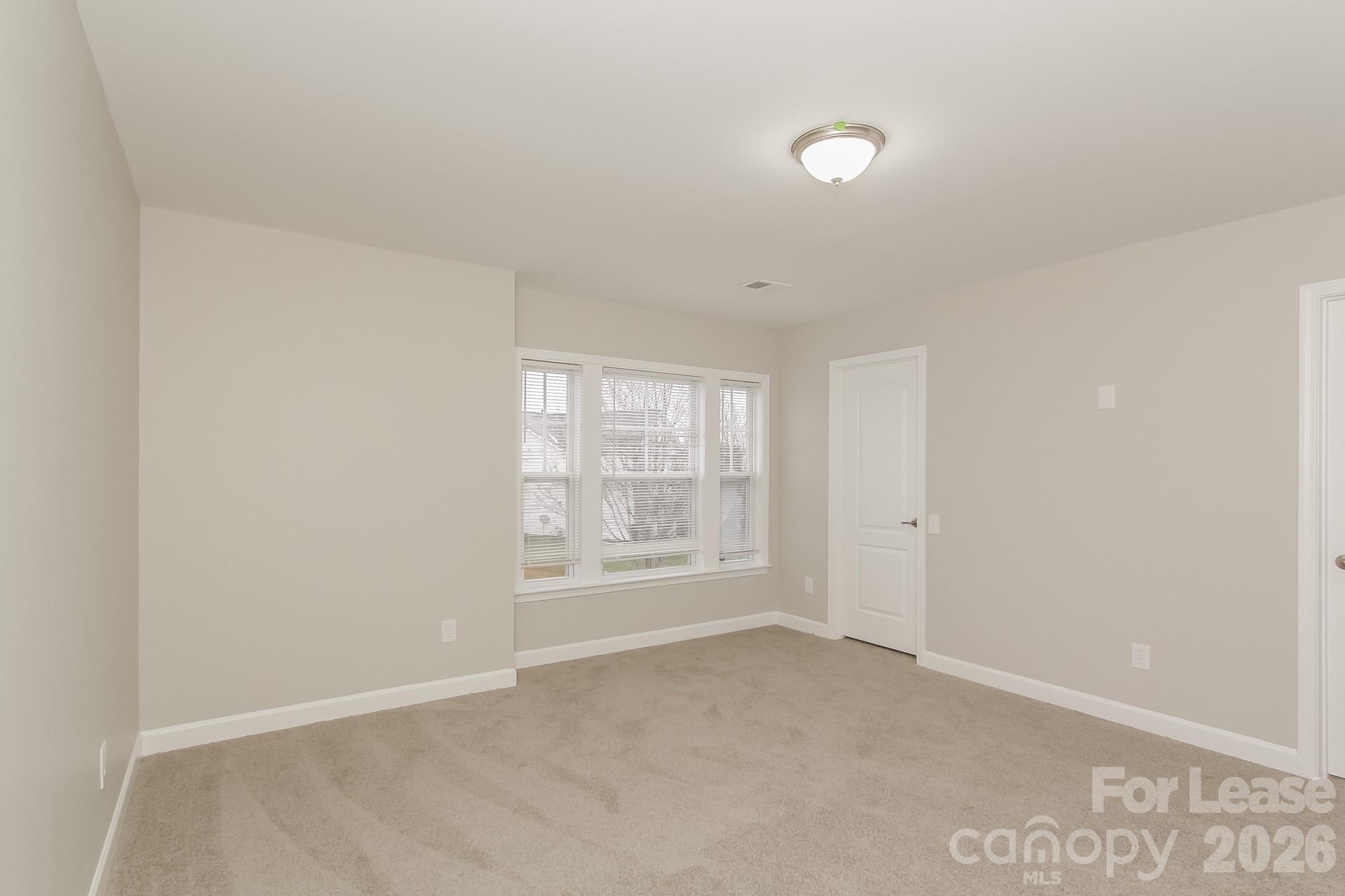 11004 Greenhead View Road Charlotte, NC 28262 - Photo 8 of 17 a view of an empty room with a window