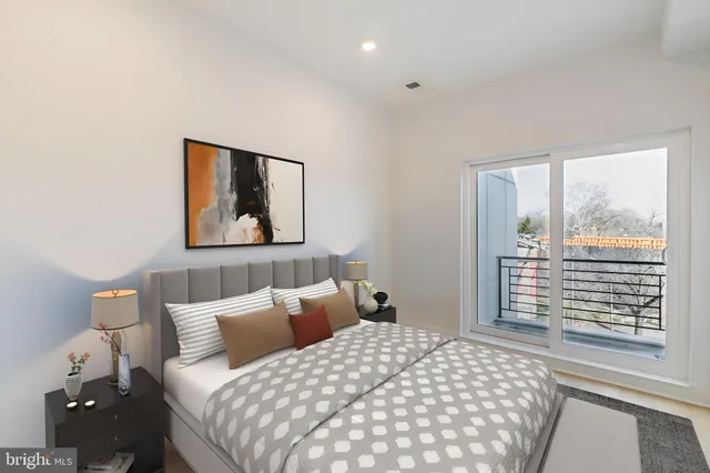 a bedroom with a bed and a large window