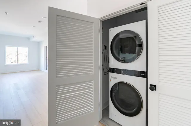 a view of a hallway with washer and dryer
