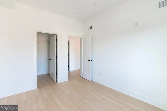 a view of hallway with wooden floor
