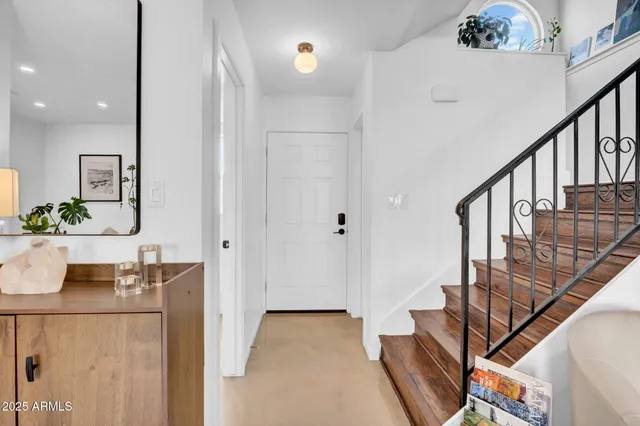 a view of hall way with furniture and stairs