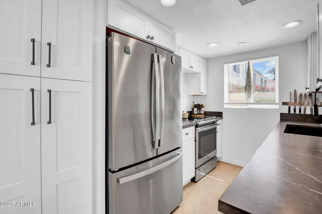 a kitchen with stainless steel appliances a refrigerator and a stove top oven