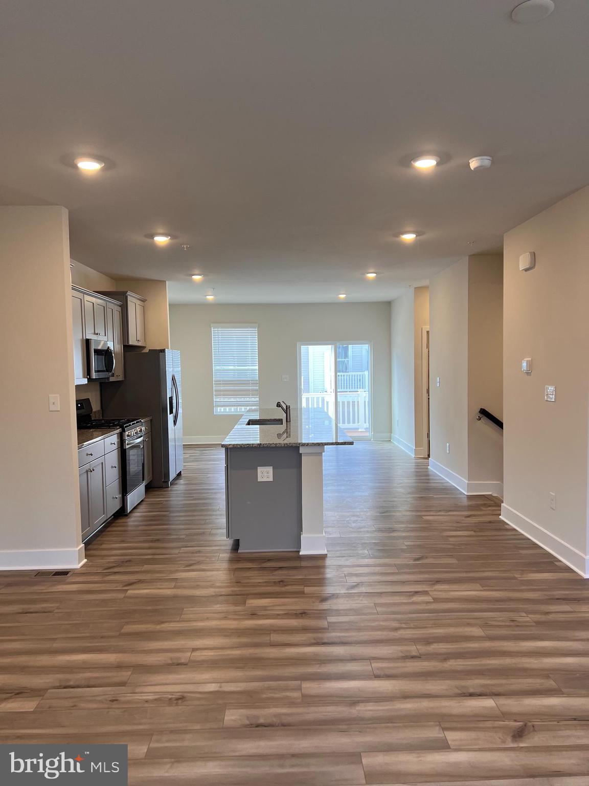 13931 Anderson Garden Road Laurel, MD 20707 - Photo 18 of 32 a view of kitchen with kitchen island stainless steel appliances refrigerator stove microwave and cabinets