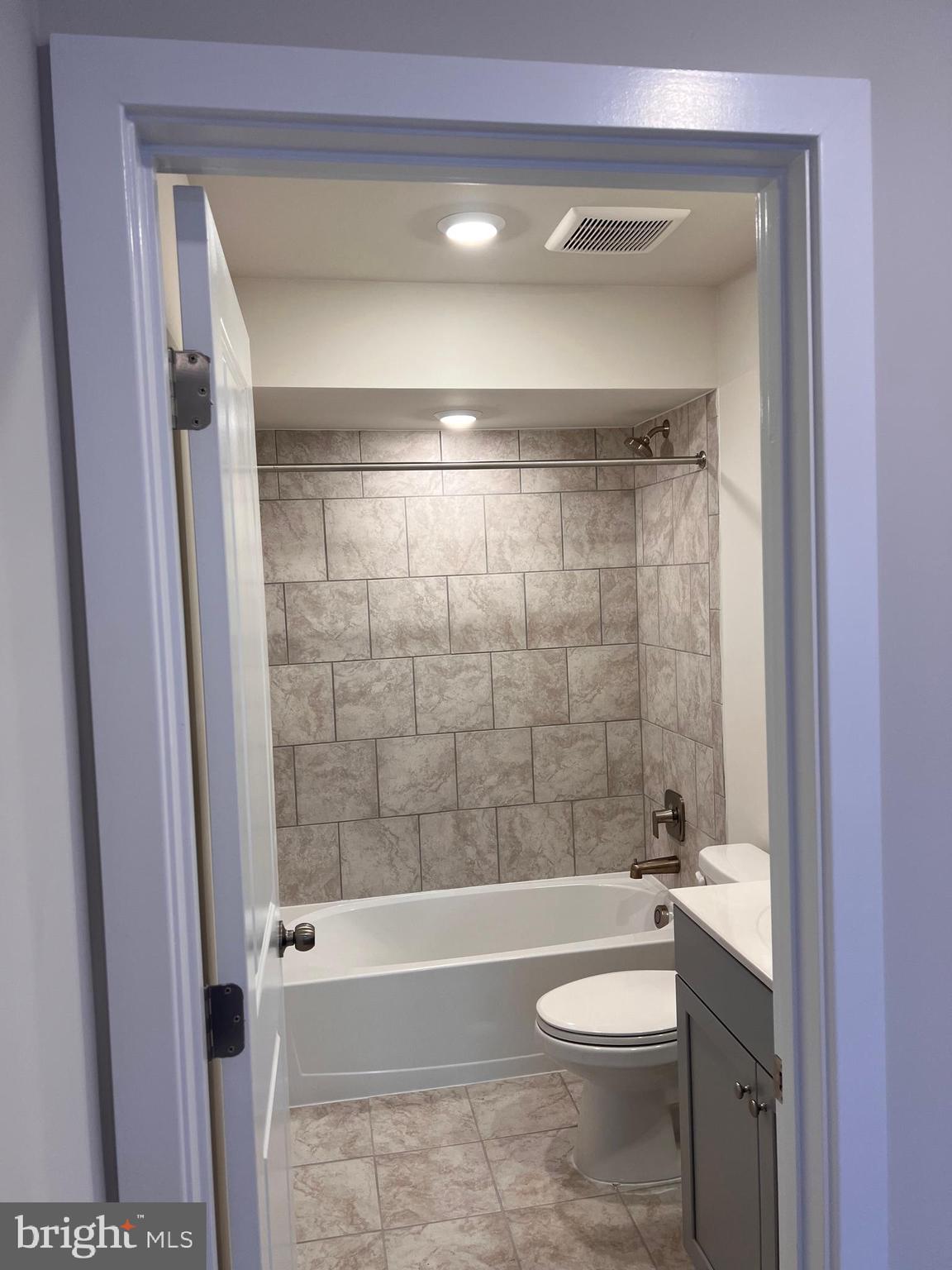 13931 Anderson Garden Road Laurel, MD 20707 - Photo 32 of 32 a bathroom with a toilet a sink and bathtub