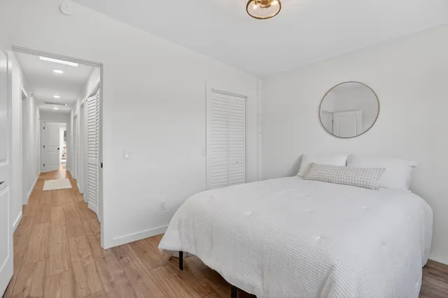 a bathroom with a granite countertop sink a toilet and mirror