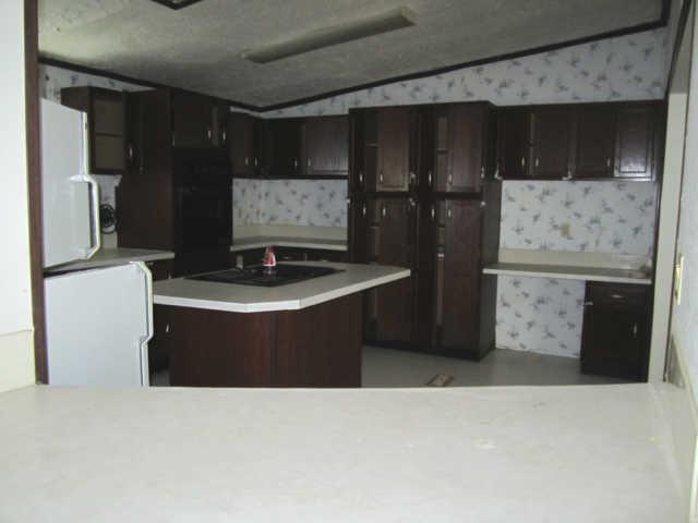 2243 Kimbrough Road Prospect, TN 38477 - Photo 8 of 20 a kitchen with stainless steel appliances kitchen island refrigerator stove and sink