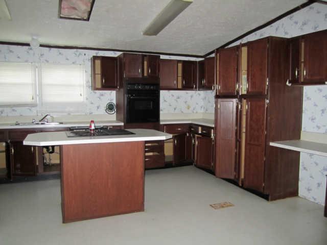 2243 Kimbrough Road Prospect, TN 38477 - Photo 9 of 20 a kitchen with refrigerator and cabinets