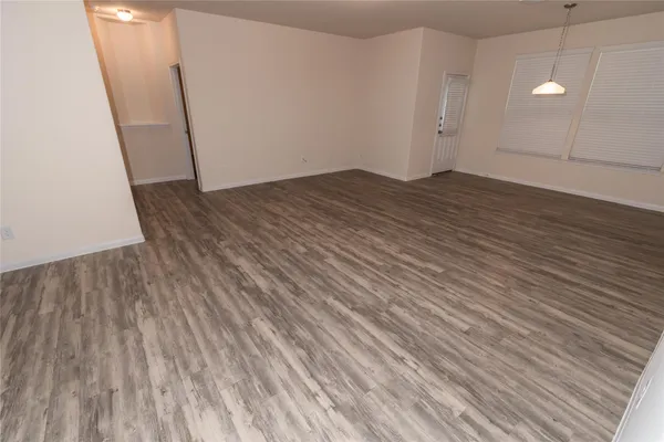 an empty room with wooden floor