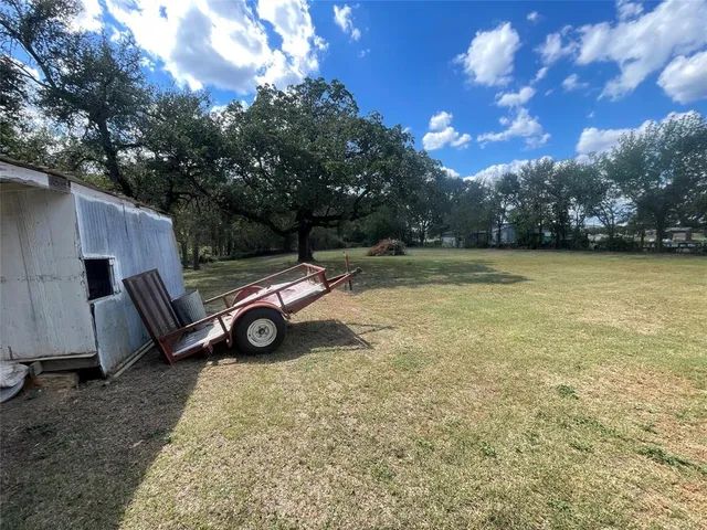a backyard of a house with barbeque oven