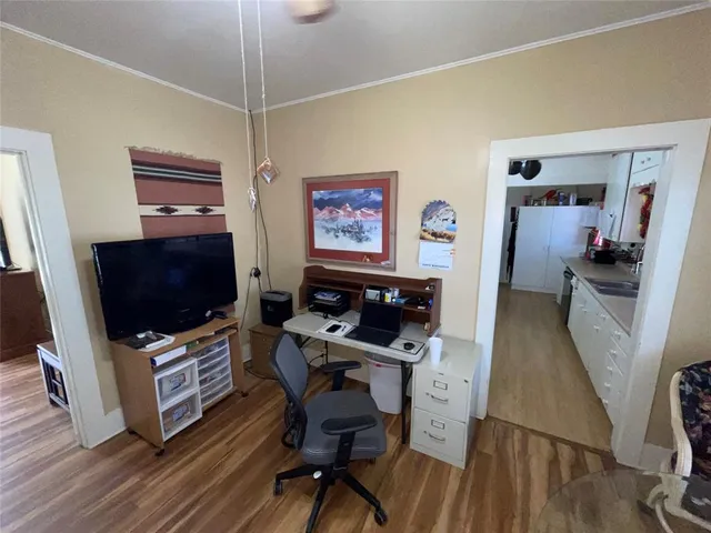 a view of a workspace with furniture and a flat screen tv