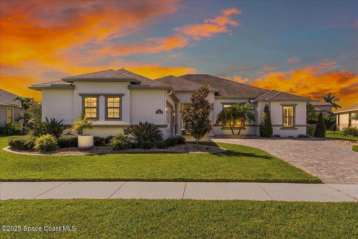 2853 Agilny Lane Melbourne, FL 32940 - Photo 1 of 2 a view of a white house with a big yard and potted plants
